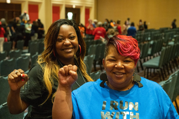 Two Black women UE members with raised fists