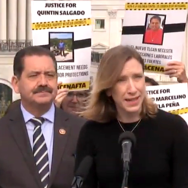Sister Quincy Howard speaking into a microphone with Congressman Chuy Garcia next to her and a placard reading "Justice for Quintin Salgado" behind them.
