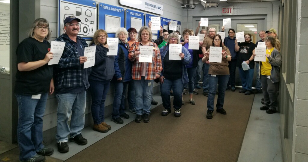 UE Local 1107 members demonstrating in their plant with signs