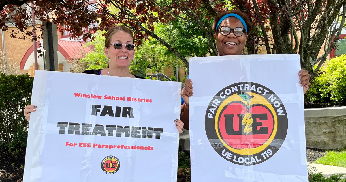 Two women with signs reading Winslow School District: Fair Treatment for ESS Paraprofessionals and Fair Contract Now UE Local 119
