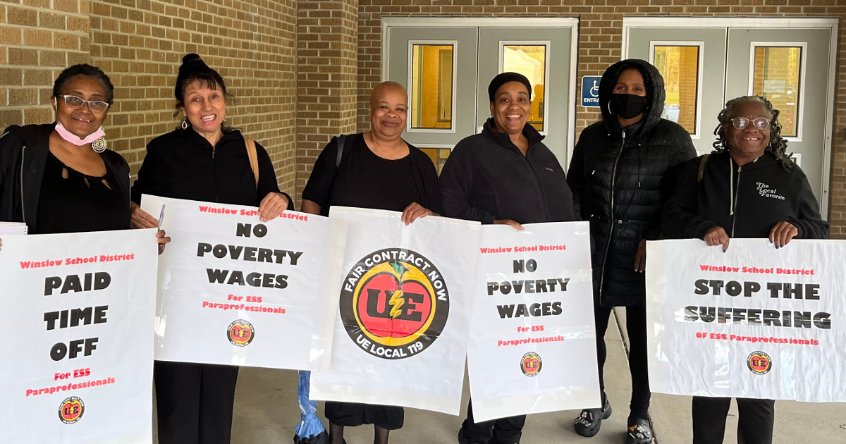 UE Local 119 members with signs reading Fair Contract, No Poverty Wages, Paid Time Off and Stop the Suffering