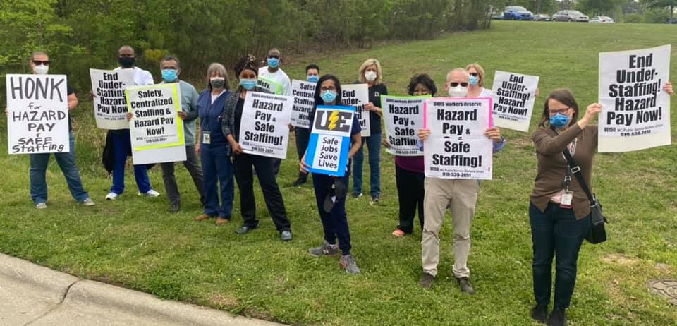 UE members with signs demanding hazard pay and safe staffing