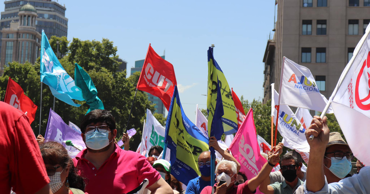 Chilean union members with flags rally for Gabriel Boric