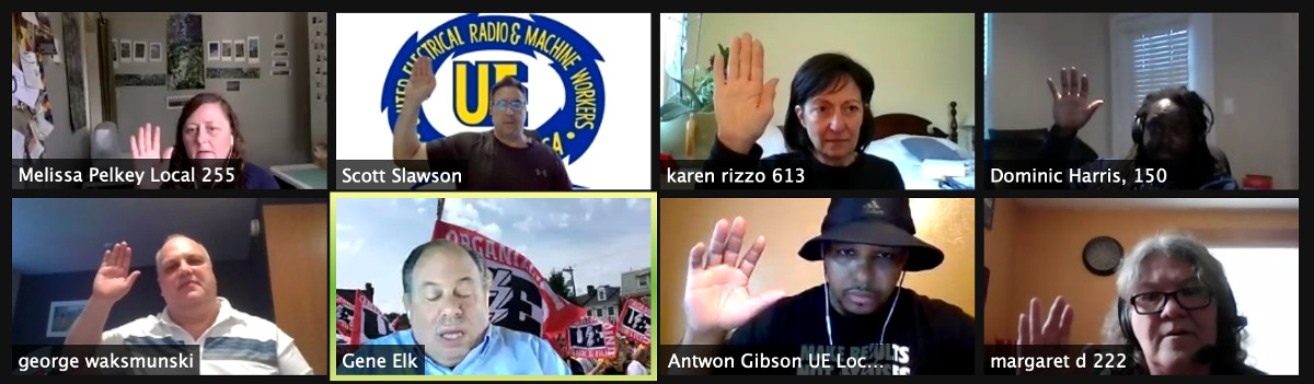 Eight UE members on a Zoom conference with their hands raised, taking an oath