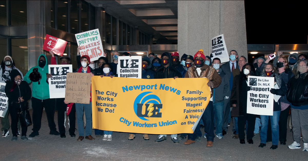 Group of workers with Newport News City Workers Union banner and signs supporting collective bargaining