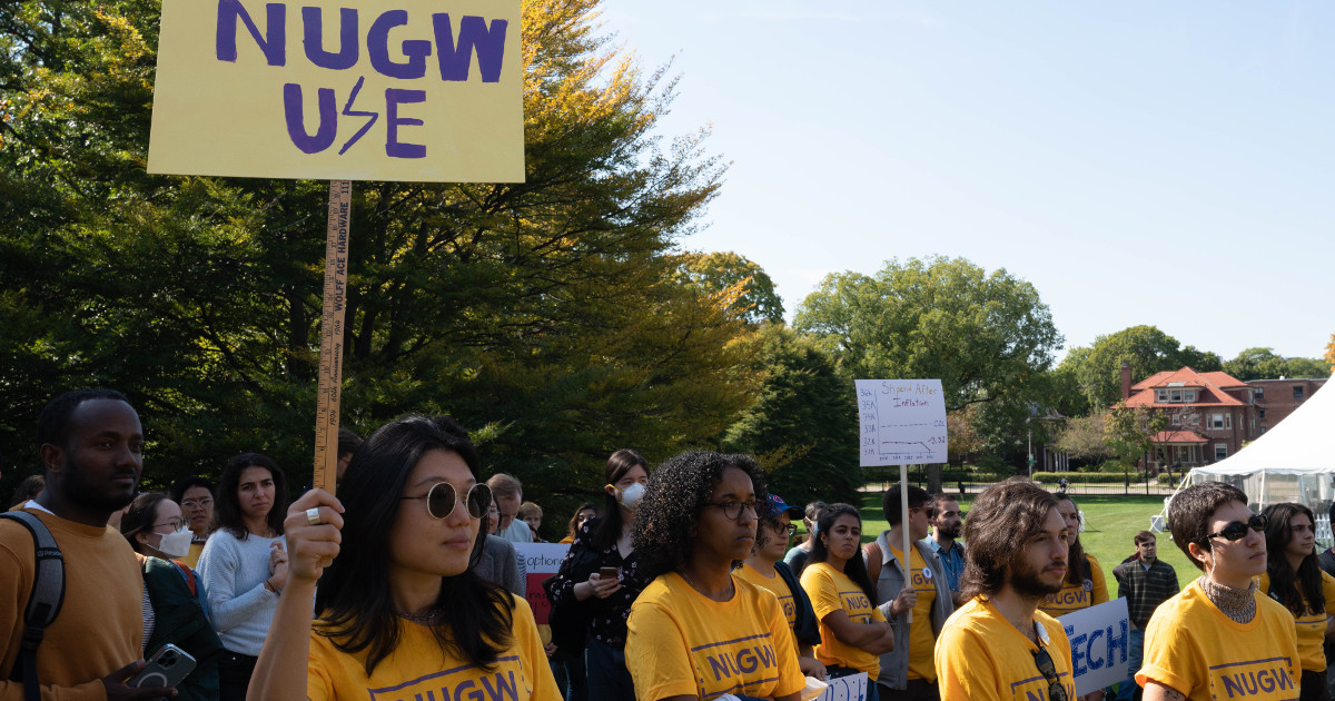 Northwestern University graduate workers rally to launch their union drive. Worker in front holds sign reading NUGW UE with a lightning bolt.