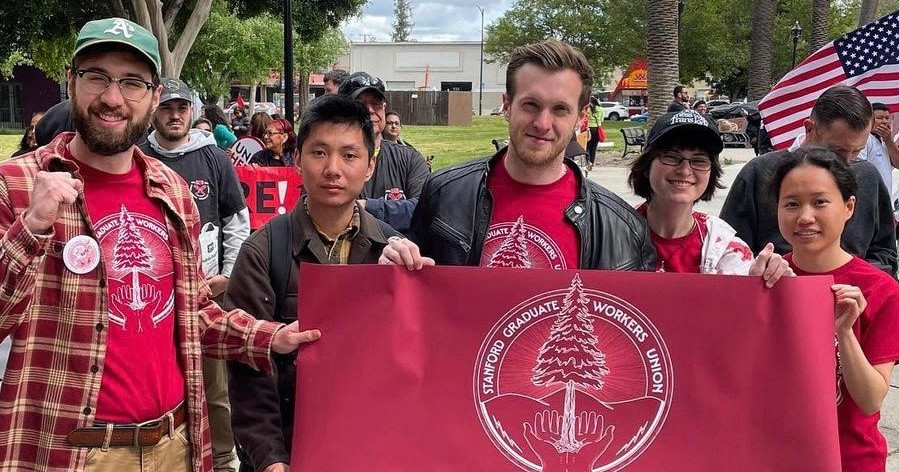 Members of the Stanford Graduate Workers Union with banner