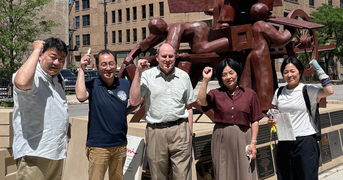 Four Zenroren members and one UE member in front of the Haymarket Memorial in Chicago