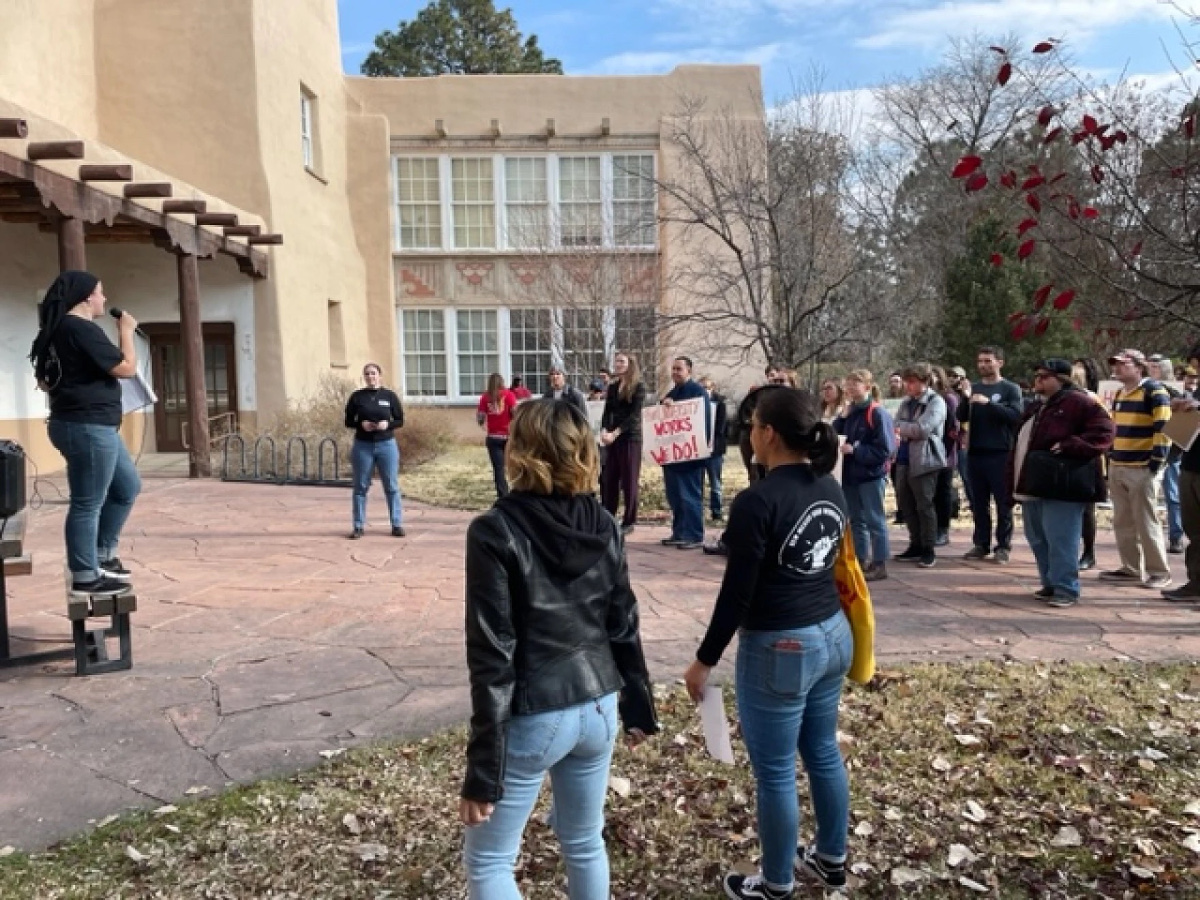 Lauren Martin, a master's student in French gives a speech at the United Graduate Workers of the University of New Mexico rally outside Scholes Hall on campus.