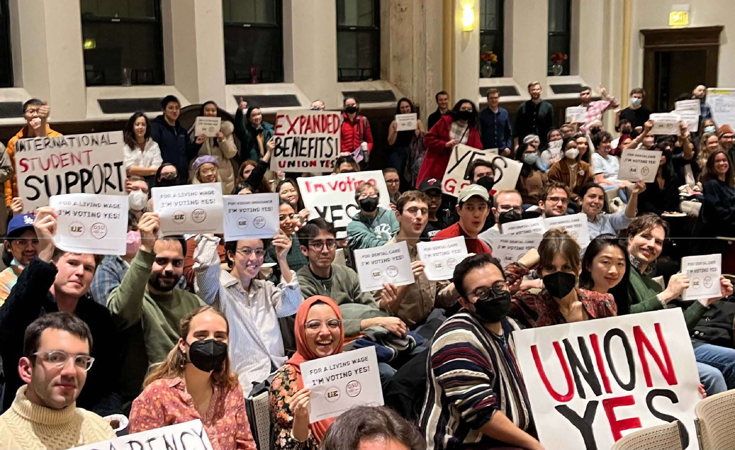 UChicago Graduate Student Union-UE members holding I'm Voting Yes signs