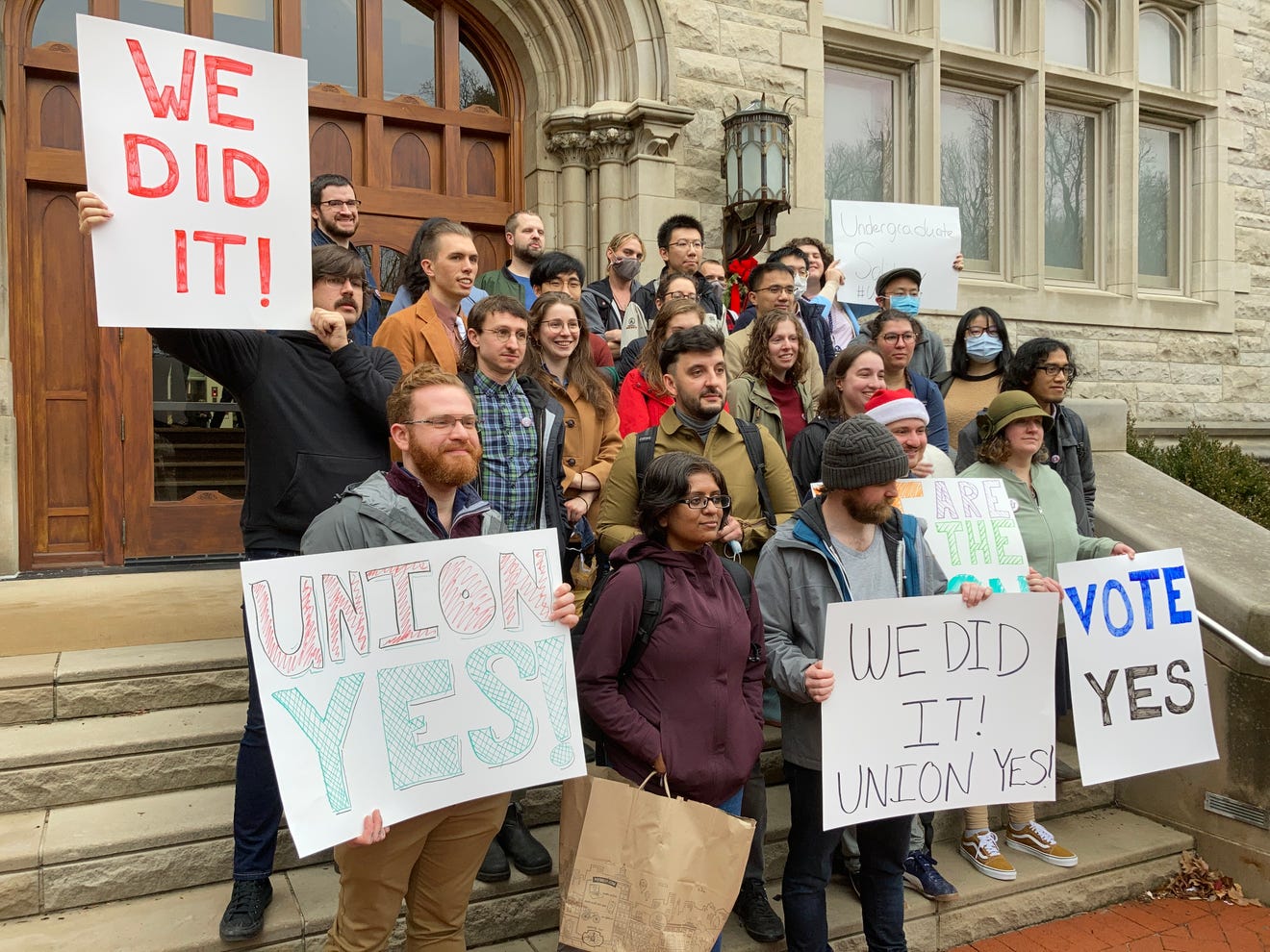 Members of the Indiana Grad Workers Coalition with signs reading We Did It, Union Yes and Vote Yes