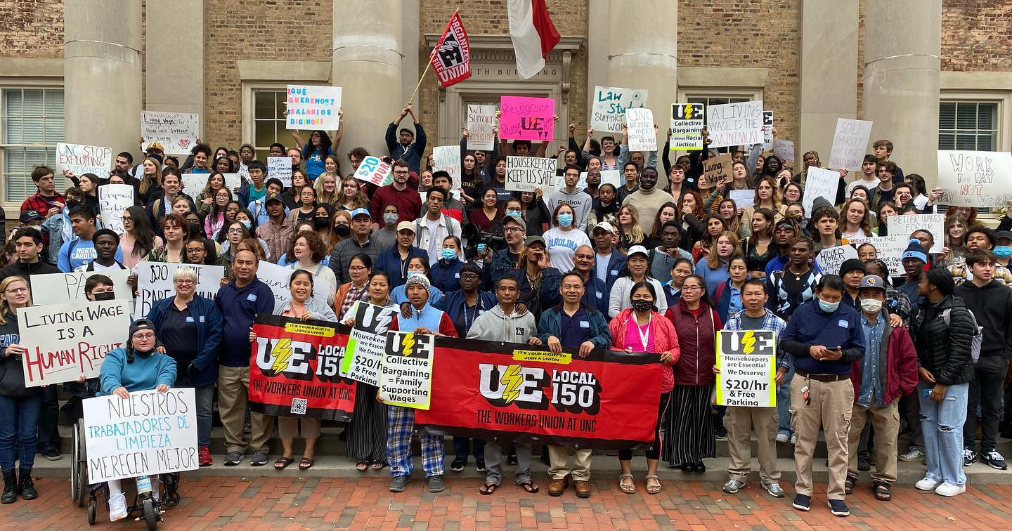 UNC Housekeepers and supporters pose for a group photo on steps of UNC building