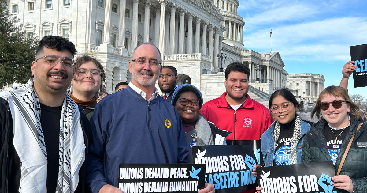 UE and UAW members posing in front of Congress with signs reading Unions for Ceasefire Now