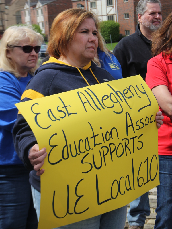 Woman holding a sign reading East Allegheny Education Association Supports UE Local 610