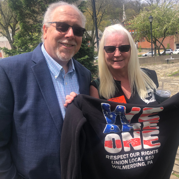 Wilmerding Mayor Greg Jakub with Local 610 Financial Secretary Rose Schmidt, who is holding up a Local 610 sweatshirt that reads WE ARE ONE