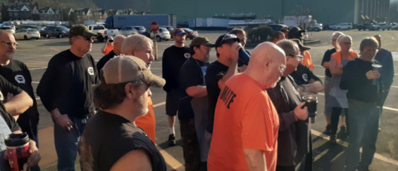 Workers rallying outside of a manufacturing plant