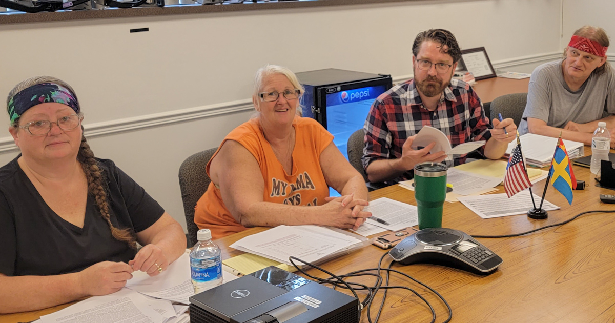 The Local 735 negotiating committee sitting at a table