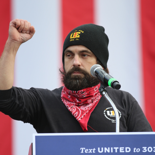 Bryan Pietrzak with raised fist and UE cap