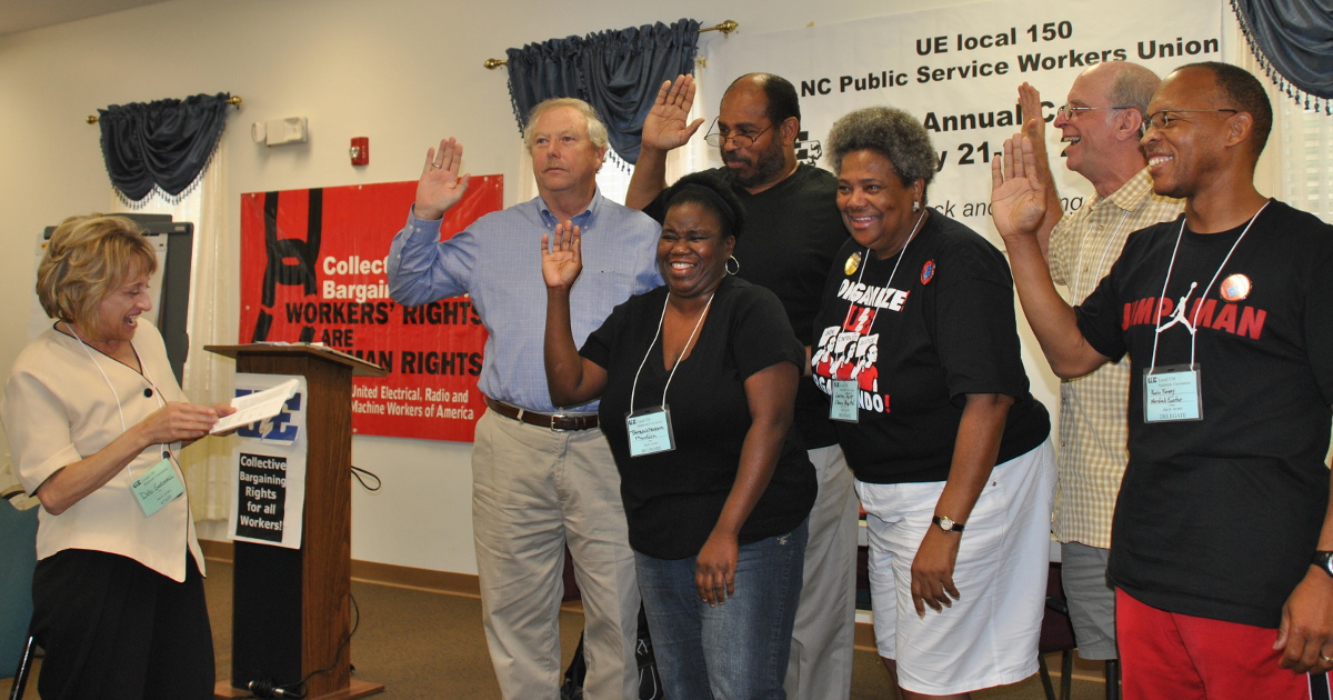 Deb Gornall laughing with a group of UE Local 150 members