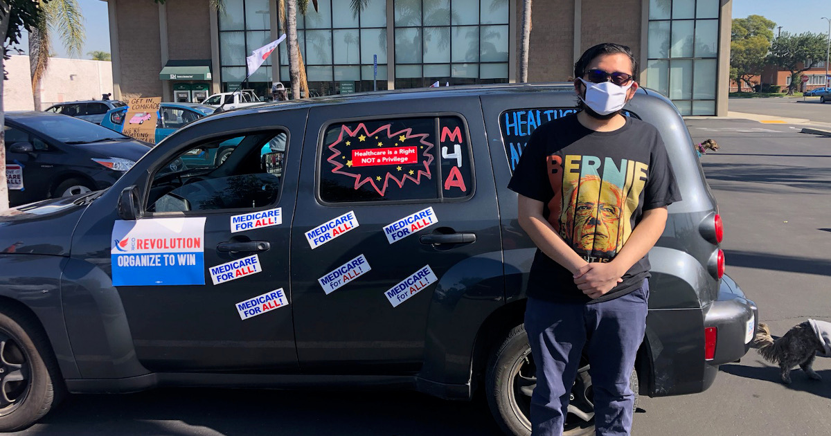 UE member Fred Hatef in front of a car covered with Medicare for All stickers