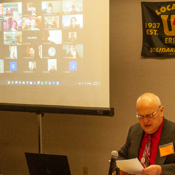 Eastern Region President George Waksmunski with a screen displaying a Zoom meeting