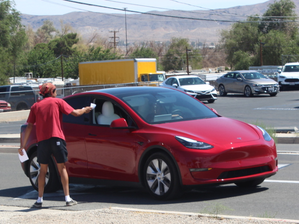 Worker talking to a driver in a car