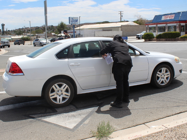 Worker talking to a driver in a car