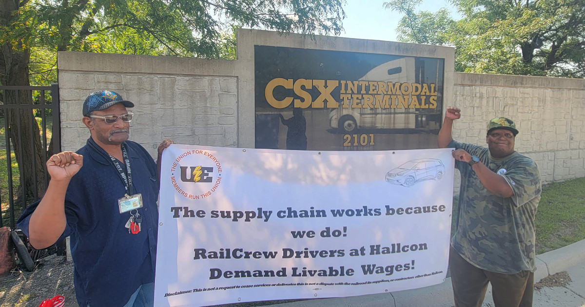 UE members with banner reading The supply chain works because we do! Railcrew drivers at Hallcon demand livable wages!