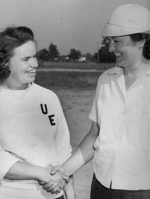 Helen Quirini, right, captain of the UE Local 301 women’s softball team, greets Grace Jones, captain of the team from the UE-GE local in Pittsfield, Mass.