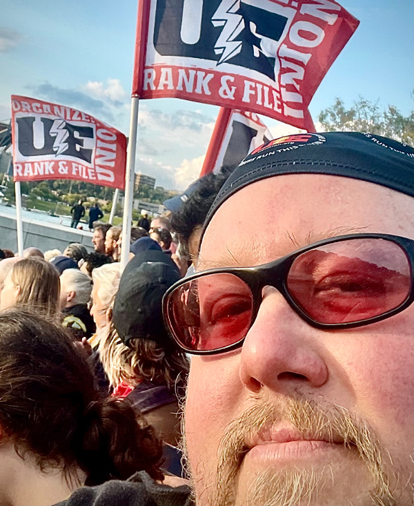 Mike Tomaloff with UE flags in the background