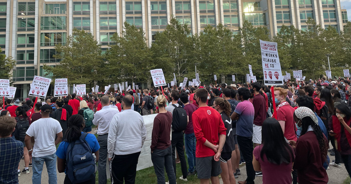 MIT graduate workers rally with MIT Works Because We Do signs