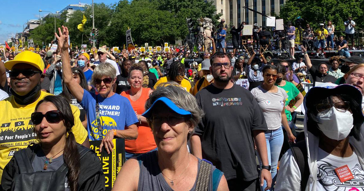 A crowd of people with signs