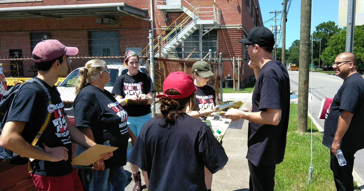 Group of UE and Unifor members standing on the street talking