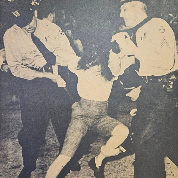 Woman being grabbed by two policemen