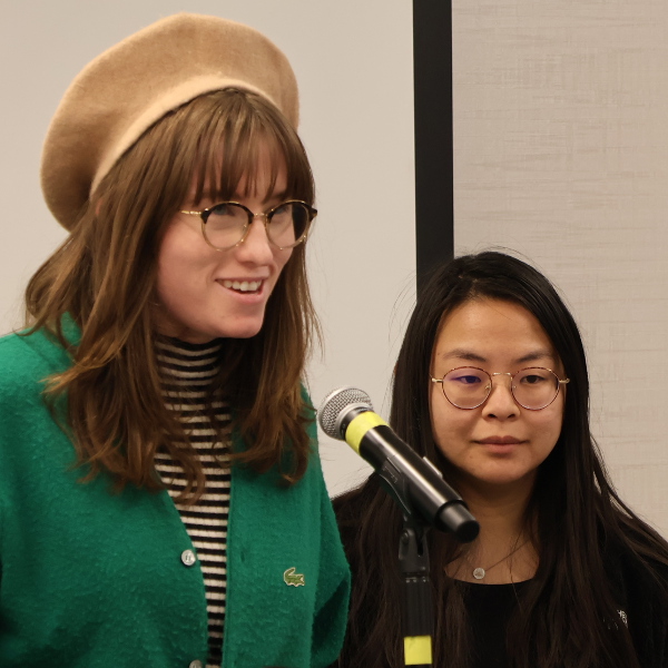 Two women speaking at a podium