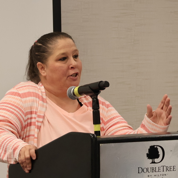 Jessica Van Eman speaking at a podium